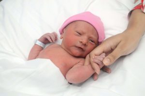 Newborn baby holding mama's hand